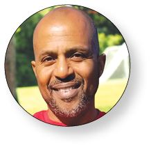 A man wearing a red shirt is smiling for the camera. AI generated content